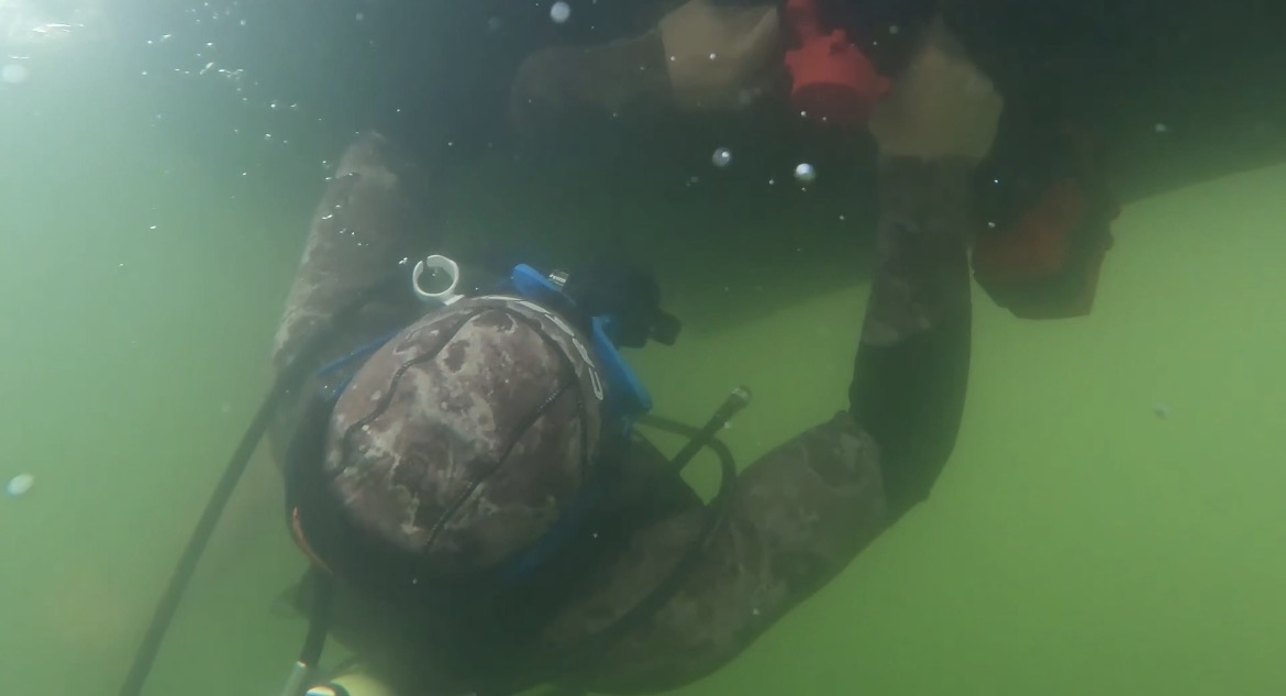 Neptune diver on a surface-supplied air line working beneath a vessel