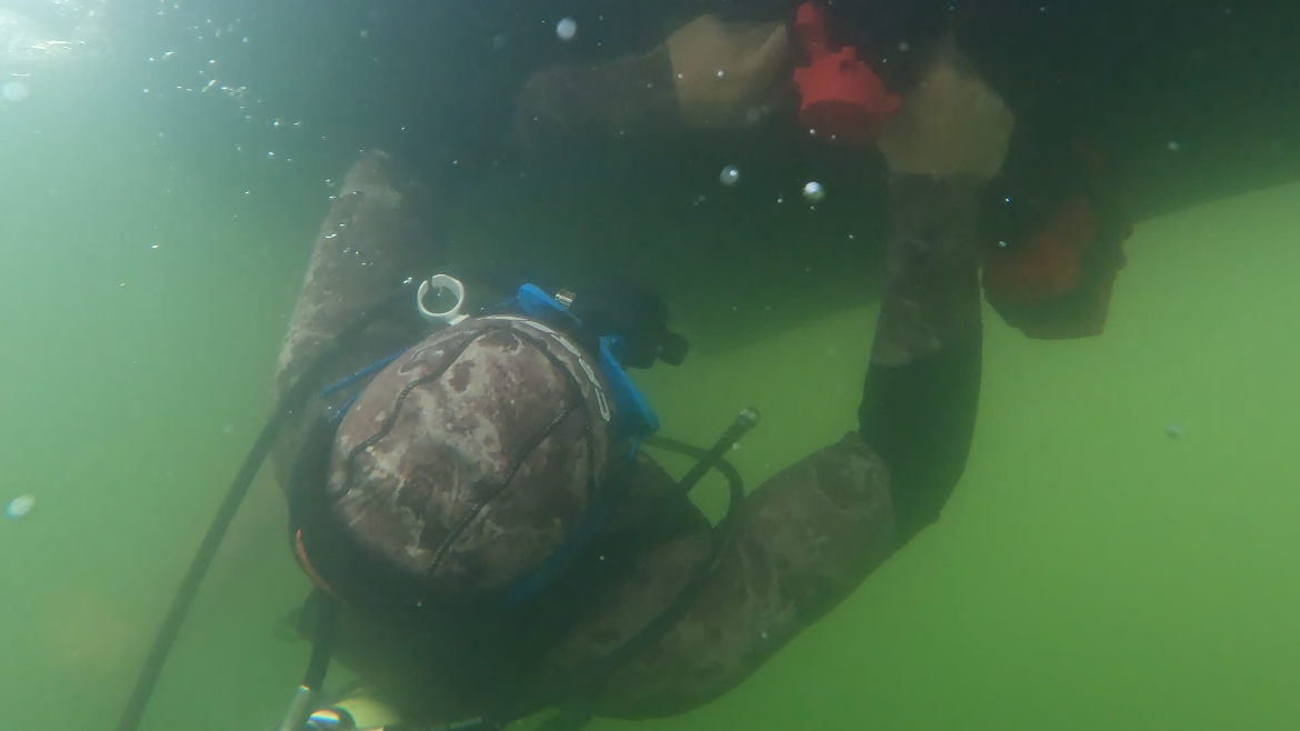 Diver performing underwater maintenance