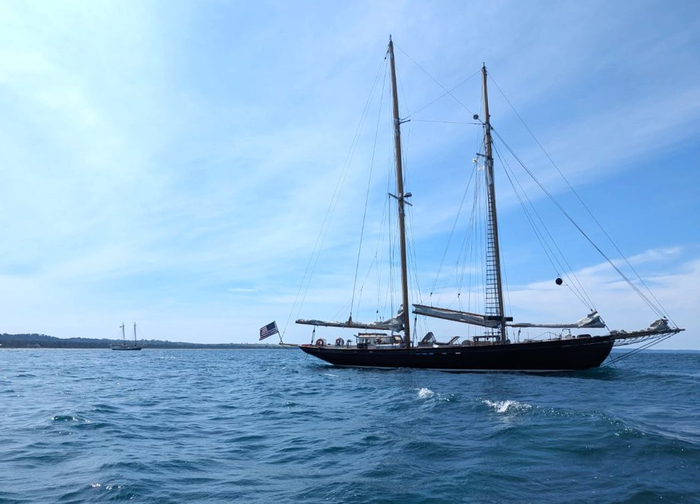 Classic schooner anchored on calm blue coastal water